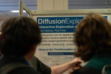 poster with to people standing in front of it 